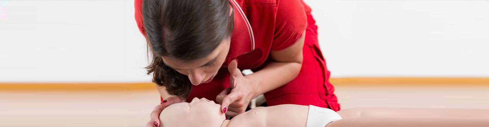a medical student doing CPR to a dummy baby